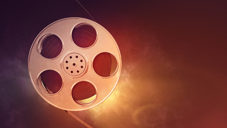 Retro film reel on burn background. Closeup with area for a text. 3d illustration の写真素材