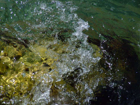 blue sea and rocks storming in light of sunsetの写真素材