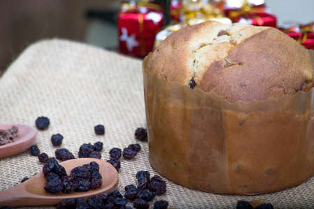 Christmas table. making panettone. with chocolate and raisin panettone. rustic table with wood and dark background. copy space.の写真素材