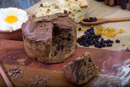 Christmas table. making panettone. with chocolate and raisin panettone. rustic table with wood and...