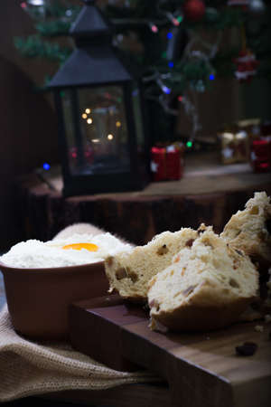 Christmas table. making panettone. with chocolate and raisin panettone. rustic table with wood and dark background. copy space.の写真素材