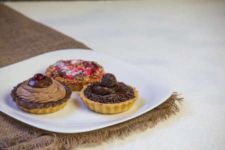 chocolate, strawberry and cream pies. space for text.の写真素材