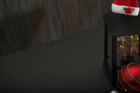 christmas ornaments on rustic table with black background.