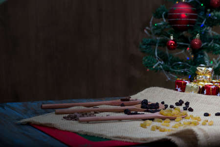 wooden spoon with chocolate and raisins for christmas. rustic table.の写真素材