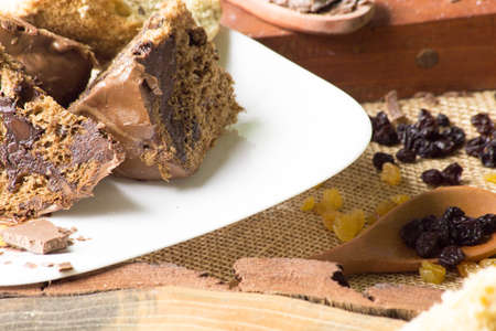 chocolate panettone on white plate. rustic table with ingredients.の写真素材