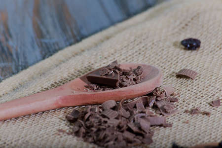 wooden spoon with chocolate. rustic wooden table.の写真素材
