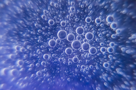 Oil in water droplets on the background