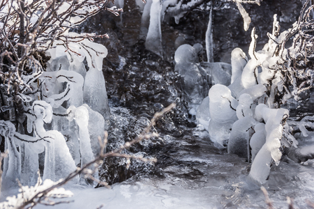 Frozen stream in iciclesの写真素材