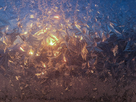 Background of frosty pattern on glass in winterの写真素材