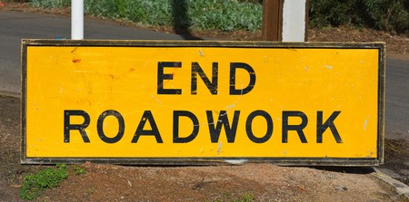 end roadwork traffic sign standing on the groundの写真素材