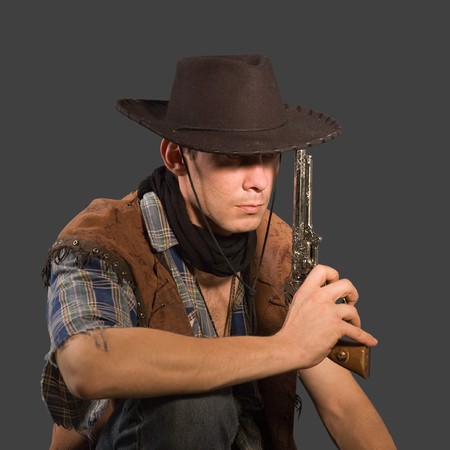 Cowboy with revolver isolated on grey background.Shallow DOFの写真素材