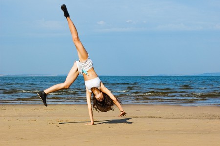 Young woman making exercise on the beach. Exercising on the beachの写真素材