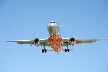 Large passenger airplane flying in the blue sky 