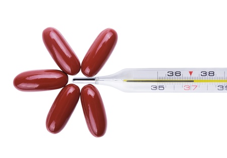 Close-up medical thermometer and tablets isolated on the white backgroundの写真素材