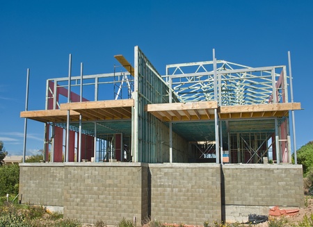 new home currently under construction against blue sky