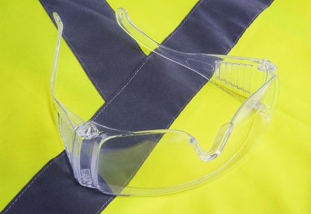 Yellow vest and protection glasses close upの写真素材
