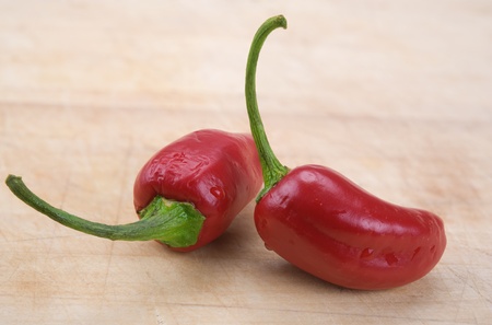 red hot chili peppers over wooden background 