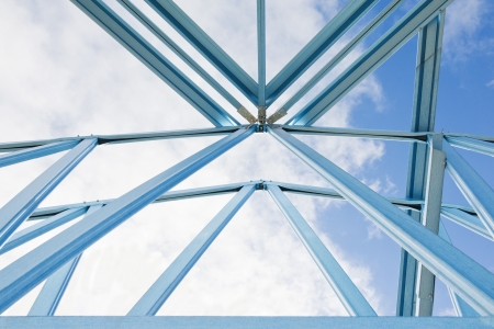 New residential construction home framing against a blue sky
