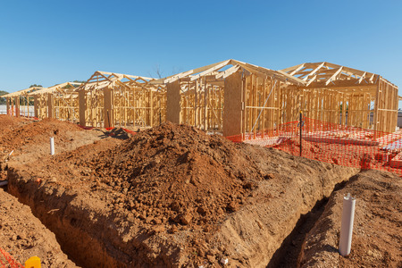 new suburban homes currently under construction in row
