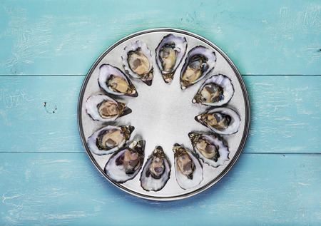 dozen fresh oysters on special cooking and serving metal tray
