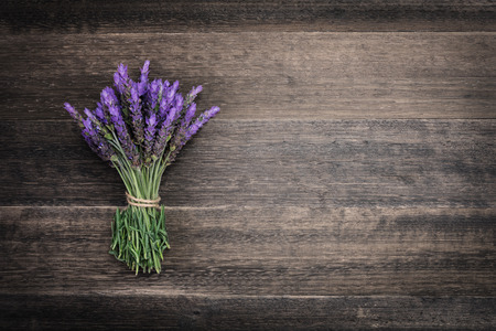 bundle of lavender flowers on on vintage wooden backgroundの写真素材