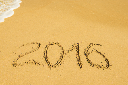 digits   2016 on the sand seashore - concept of new year and passing of timeの写真素材