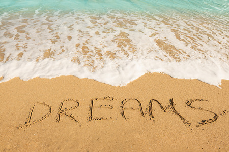 Dreams message on the beach sand - vacation and travel conceptの写真素材