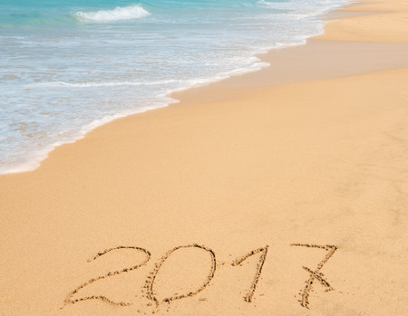 digits  2017 on the sand seashore - concept of new year and passing of timeの写真素材