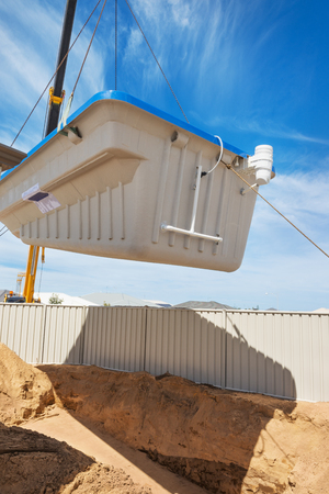 Swimming pool under construction.
Installation plastic   pool in the ground at house backyardの写真素材