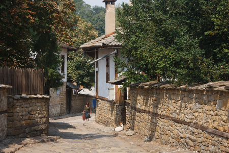 LOVECH, BULGARIA - SEPTEMBER 2: Woman walking up the street in the old town of Lovechのeditorial素材