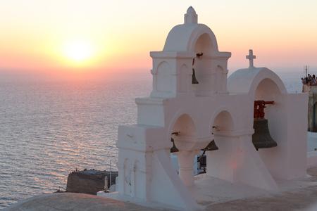 OIA / GREECE - AUGUST 2014: Traditional church in Cyclades style during sunset, Oia village, Santorini island, Greeceのeditorial素材