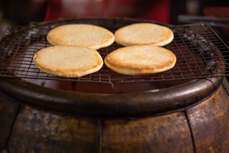 fresh grilled pastries, oven bread at an Asian night marketの写真素材