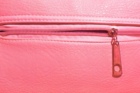 pink bright leather background with zipper lock, copy spaceの写真素材
