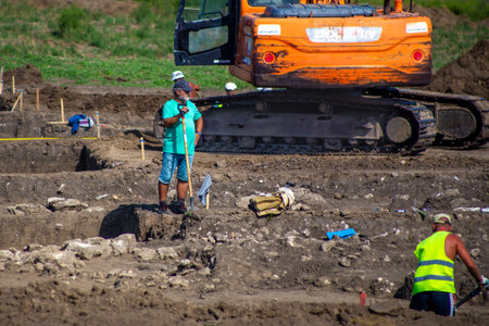Anapa, Russia - 08.21.2019: Work crew digging a trench on a summer dayのeditorial素材