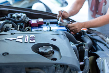 Krasnodar, Russia - 08.28.2019: A man with a wrench makes a car repairのeditorial素材