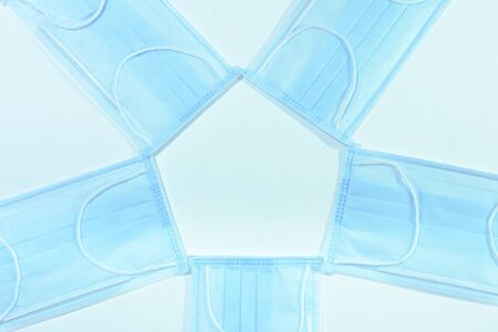 blue medical masks folded round with a middle for copy space, personal protective equipment