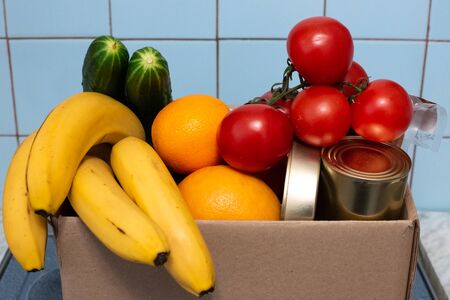 a large box with food and vegetables is in the kitchen, donations for those in need during...