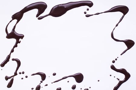 light gray background with a frame of spilled liquid chocolad, place for textの写真素材