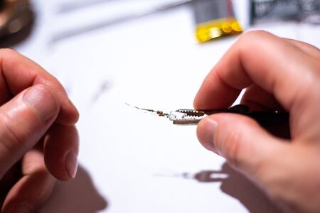 Worker in the workshop is engaged in LED repair, close-upの写真素材