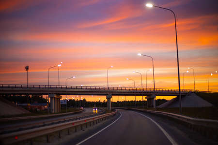 motorway in the evening with beautiful sky and sunset lighting, travel by car