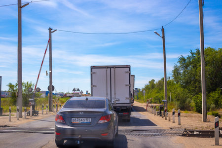 Russia, Rostov Region-07.01.2020: Transport at the railway crossing, trucks and cars cross the railwayのeditorial素材