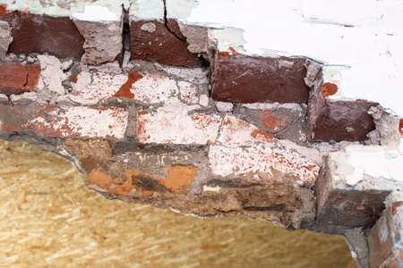 Part of an old destroyed brick wall. Repair and construction. Abandoned building