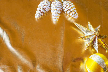 ornaments in yellow color on a sparkling golden background. Flat lay, top view, copy space.の写真素材