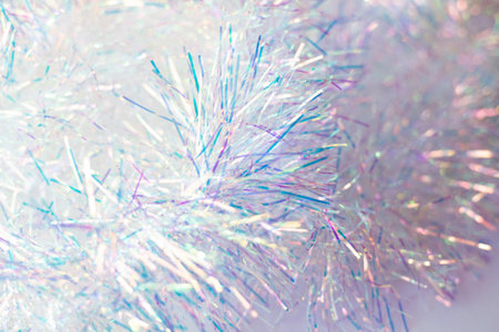 Christmas festive background. Tinsel shimmers in different colors in the light of the lights.の写真素材