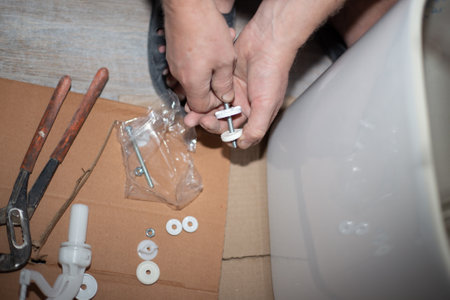 Assembling the toilet cistern. Home renovation. Plumber at work.