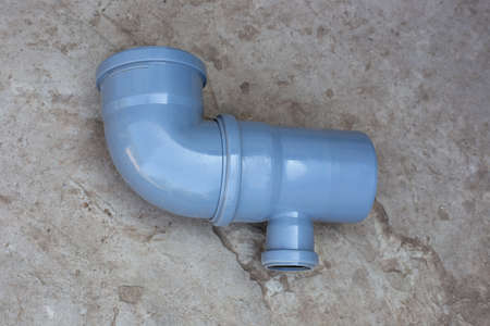 installation of a sewer pipe. Connection of plastic pipe construction, branch and tee. Plumbing system at home.の写真素材