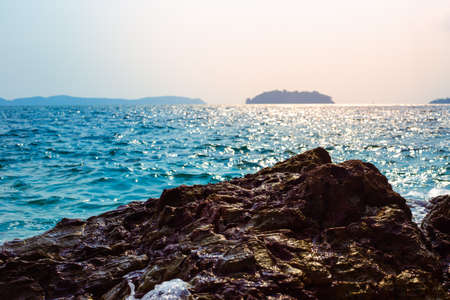 Seascape. Blue sea and rocky coast on a sunny day. Travel and tourism concept.の写真素材