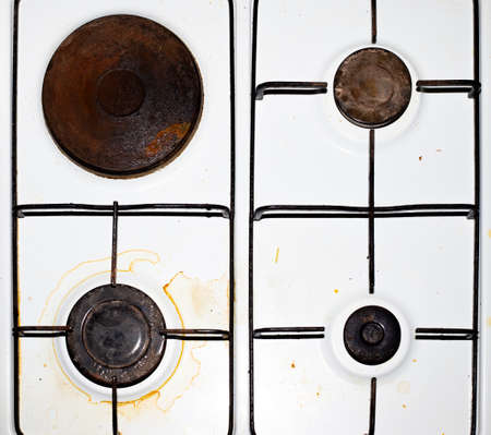 Dirty metal plate. The burners of the electric and gas combination hob become covered with dirt and grease after cooking. View from above.の写真素材