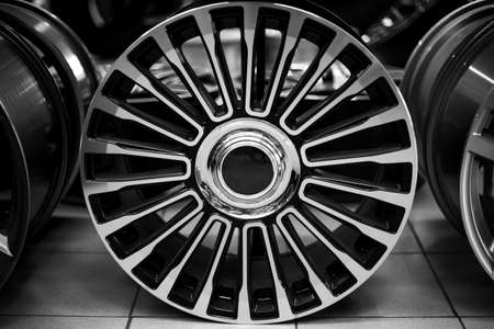 Black alloy wheels for premium cars, close-up. Purchase and replacement of autodisks.の写真素材