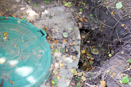 Collapsed soil near the concrete rings of an underground well. Installed septic tank, poor soil...